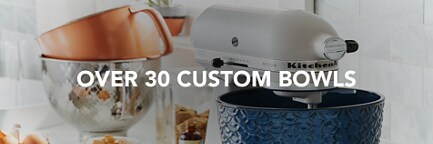 Several Stand Mixer Bowls resting on a kitchen counter.
