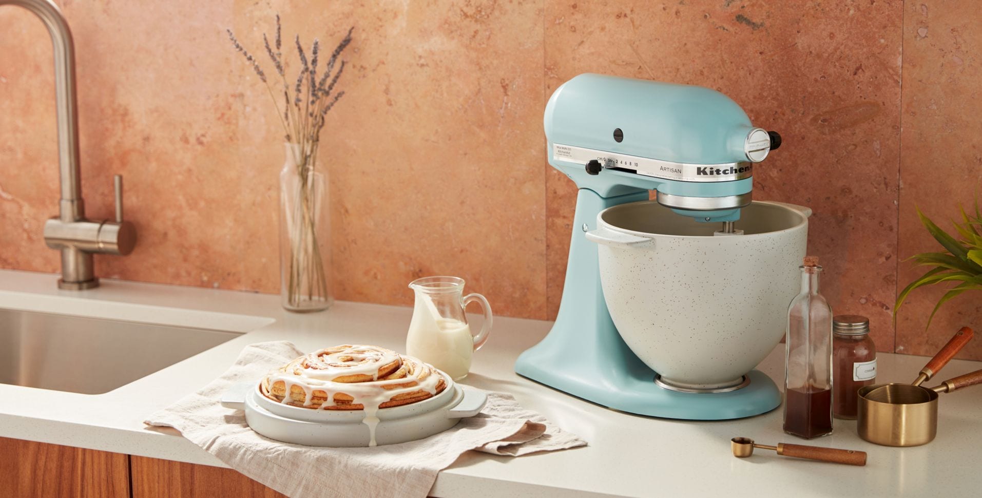 A KitchenAid® Stand Mixer side profile with baked goods
