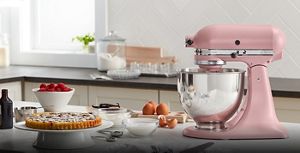 A KitchenAid® Stand Mixer side profile with berries, eggs and baked goods