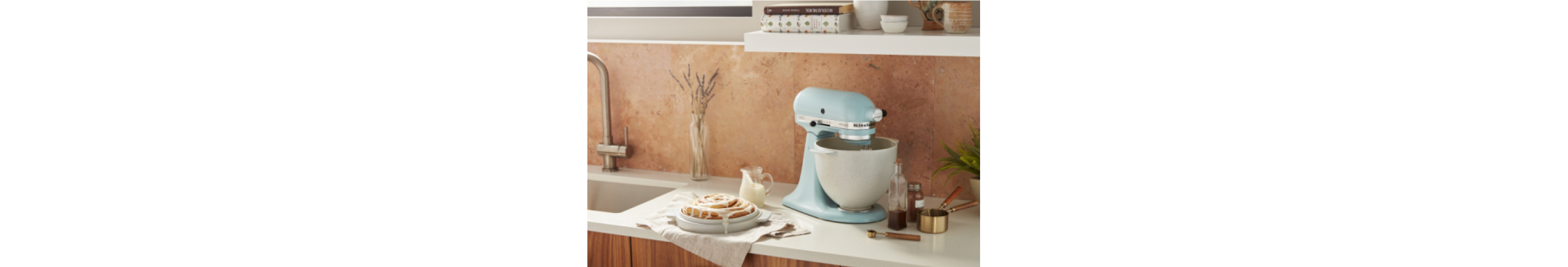 A light blue KitchenAid stand mixer on a countertop