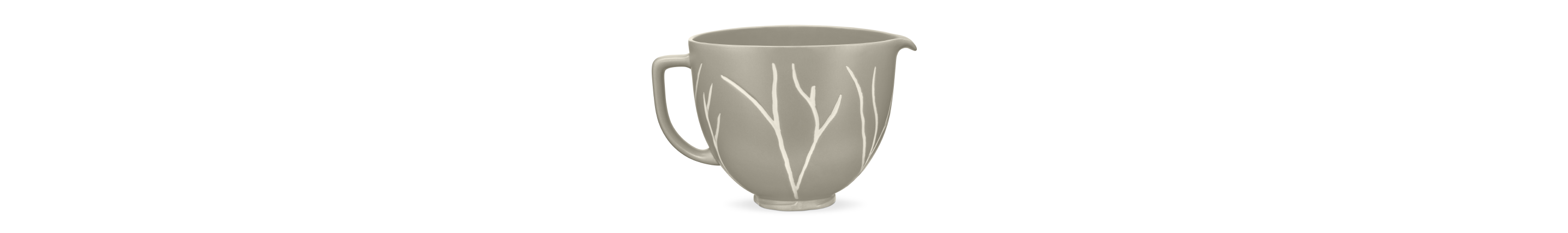 A bare leaves patterned ceramic bowl for a stand mixer.