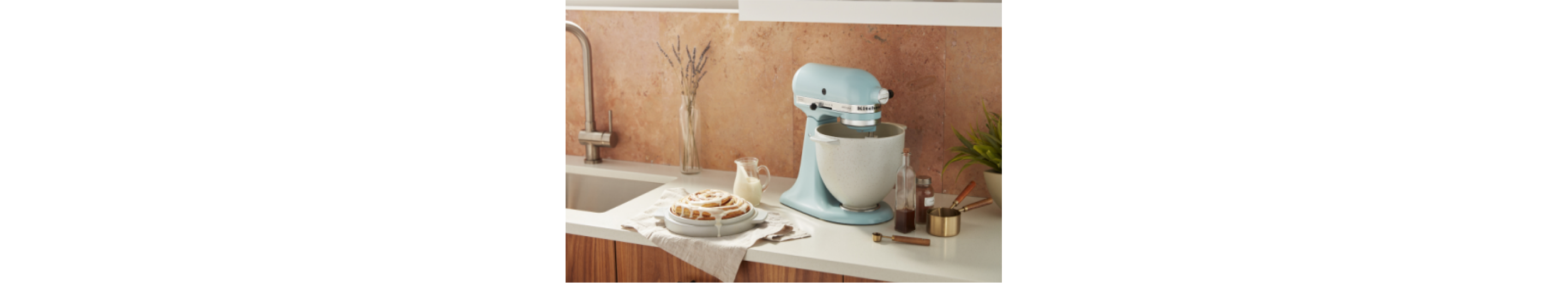 A pale blue stand mixer on a white countertop.
