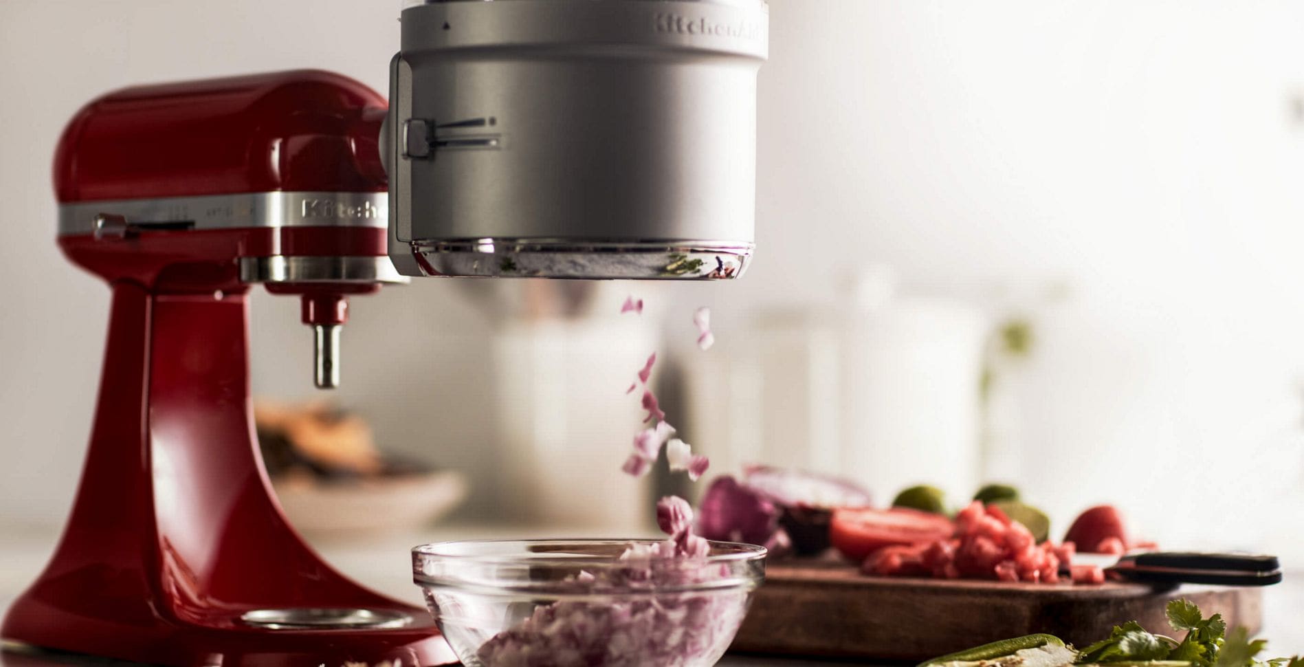 A KitchenAid® Stand Mixer with a Food Processor Attachment.