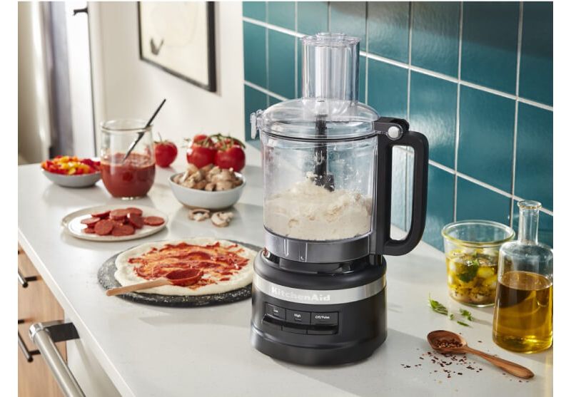 A Matte Black 9 Cup Food Processor filled with dough.