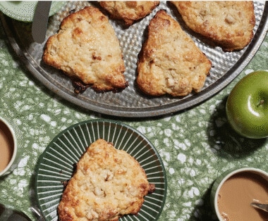 Freshly made apple pastries resting on delicate plates.