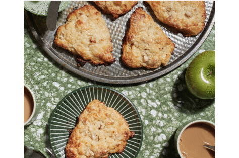 Freshly made apple pastries resting on delicate plates.