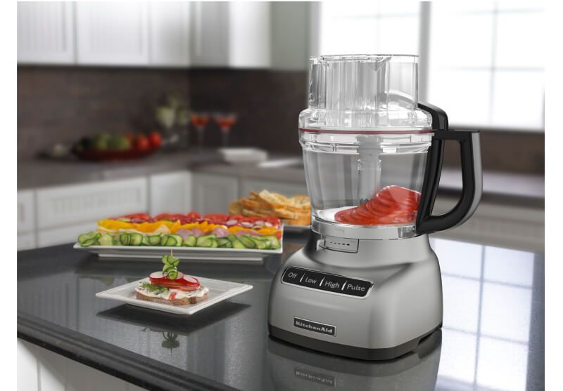 A Contour Silver 11 Cup Food Processor holding sliced tomatoes.