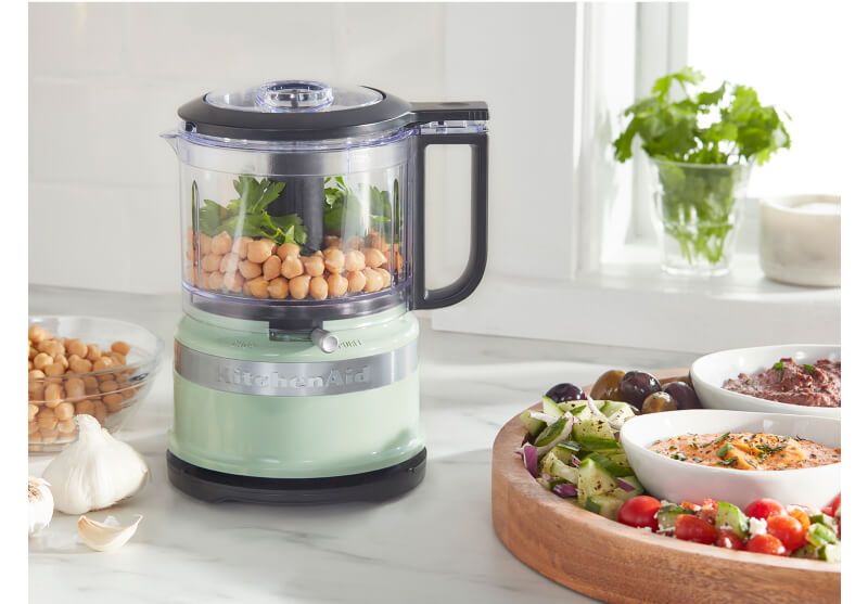 A Pistachio 3.5 Cup Food Chopper filled with chickpeas and cilantro.