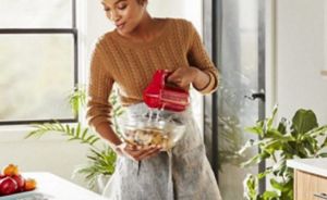 A person using a hand mixer.