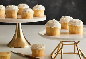 Vanilla cupcakes scattered about.