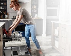 A person unloading their FreeFlex™ Third Rack Dishwasher.