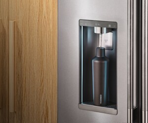 A water bottle placed underneath the Intelligent Auto Fill dispenser on a KitchenAid® refrigerator