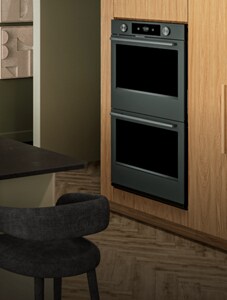 A Juniper KitchenAid® wall oven in a kitchen with light brown cabinets