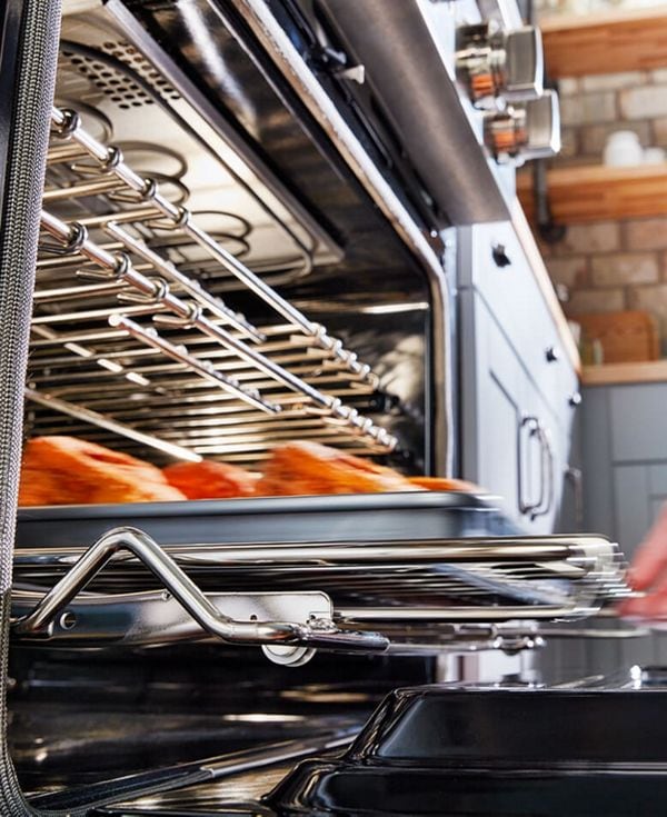 A sheetpan being removed from the oven.