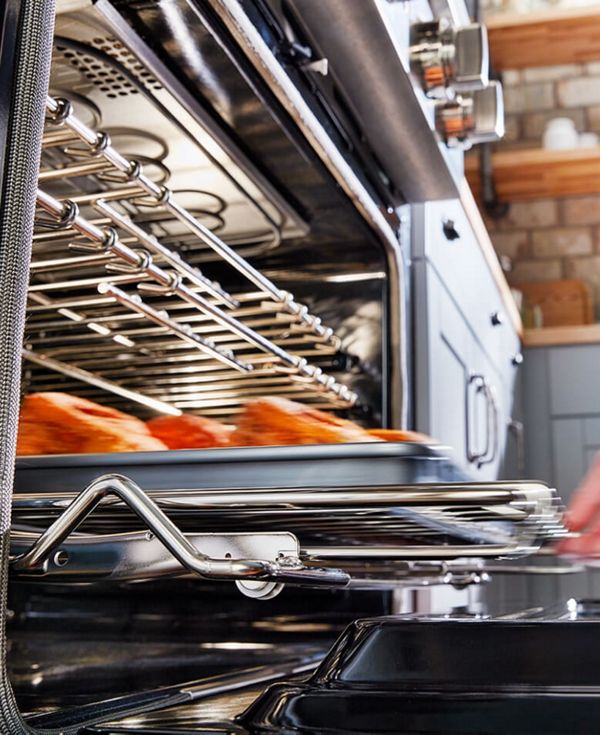A sheetpan being removed from the oven.
