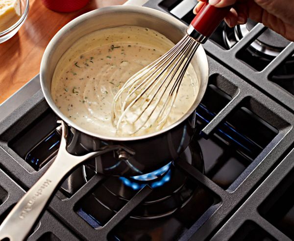 Overhead shot of a sauce being stirred over flame.