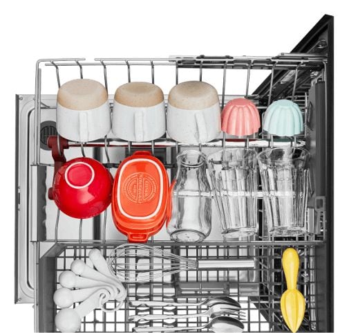 An overhead shot of a fully extended dishrack loaded with assorted dishes of varying bold colors.