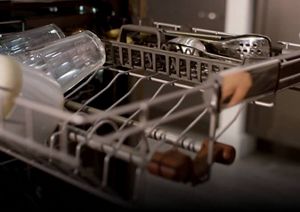 A close-up of the FreeFlex™ Third Rack's deep angle design holding clean glasses and silverware.