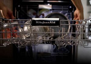 A close-up of the dishwasher's middle rack fully extended to be loaded up.