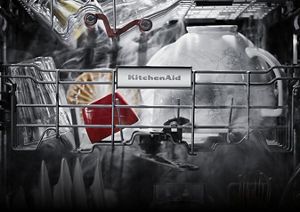 A close-up of dishes in the dishwasher enveloped in steam during a hot air drying circulation.