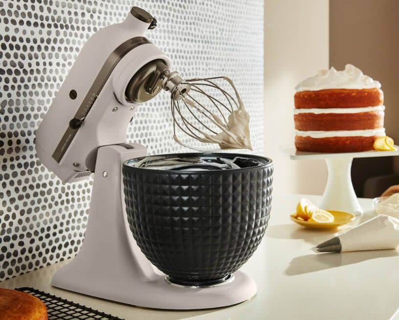 A Limited Edition Stand Mixer with Black Ceramic Studded Bowl whipping cream.