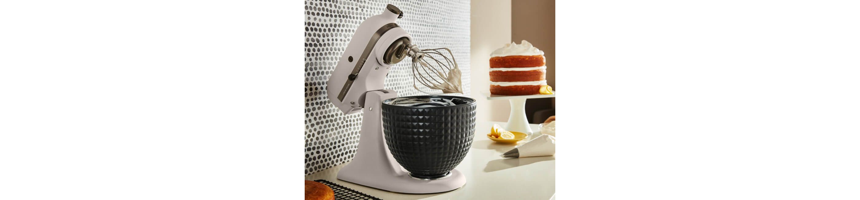 A Limited Edition Stand Mixer with Black Ceramic Studded Bowl whipping cream.