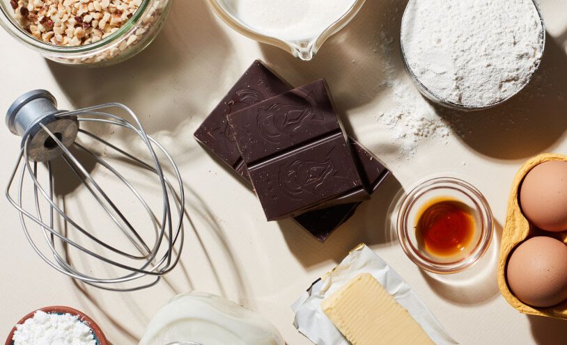 A variety of baking ingredients scattered on a kitchen counter.