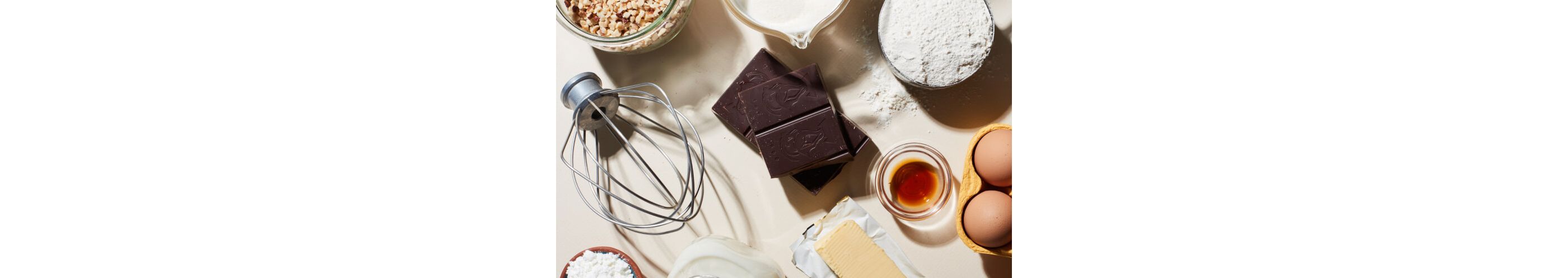 A variety of baking ingredients scattered on a kitchen counter.