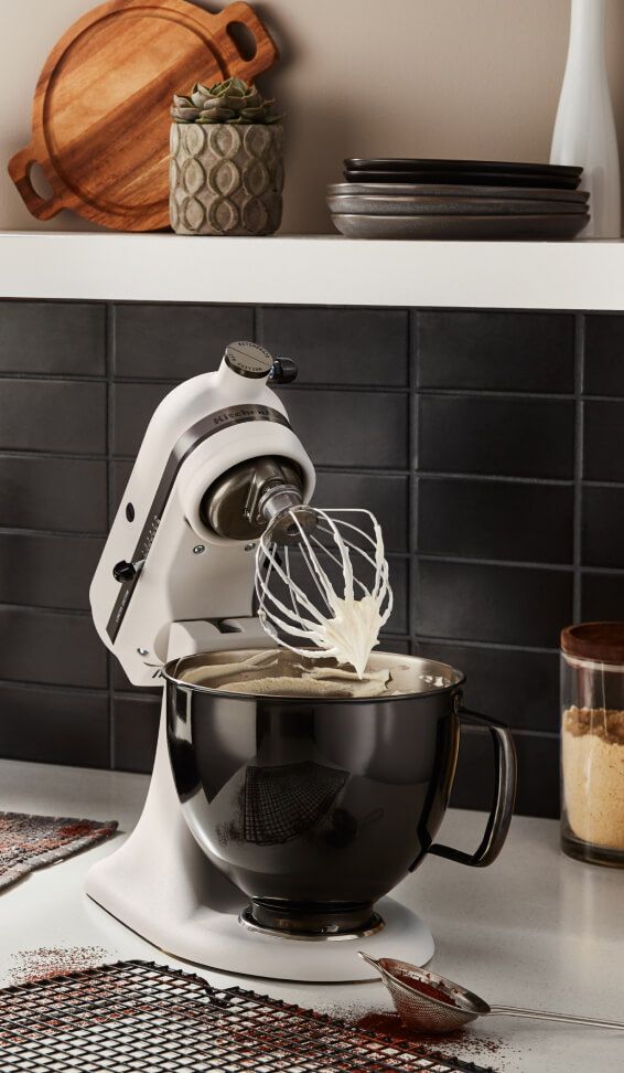 A Limited Edition Stand Mixer with Black Stainless Bowl whipping cream.