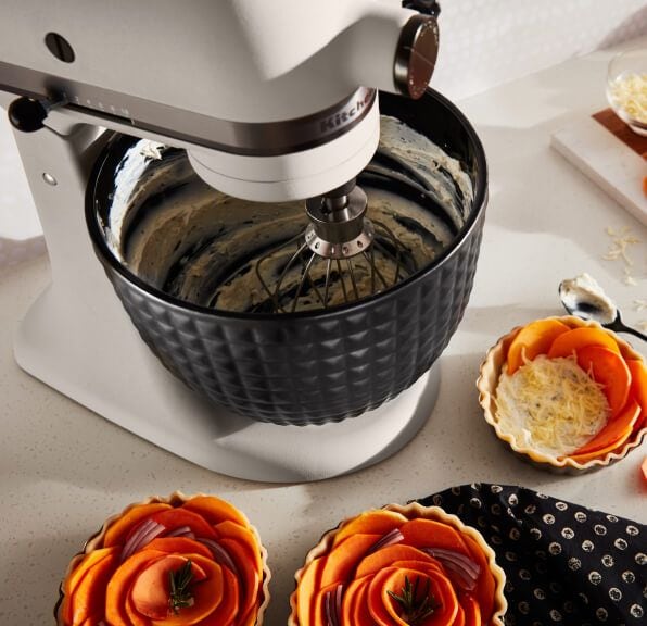 A Limited Edition Stand Mixer with Black Ceramic Studded Bowl whipping cream.