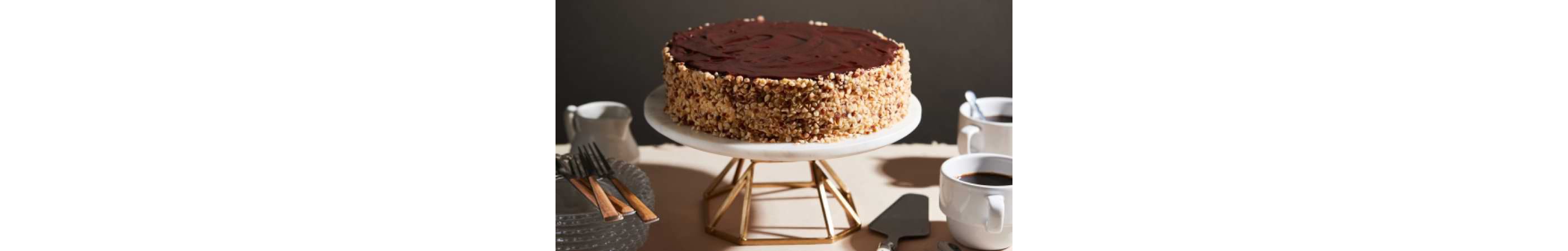A decadent cake resting on an elevated stand.