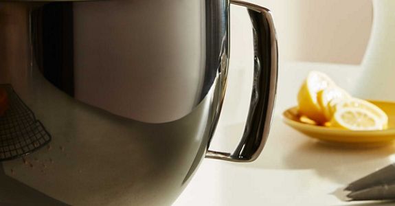A close-up of a pitcher next to lemon slices.
