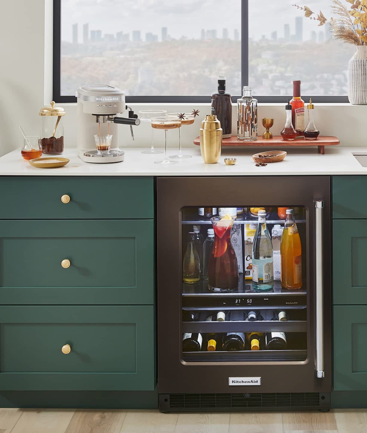 A wet bar decorated with seasonal decor and KitchenAid® appliances making espresso martinis.