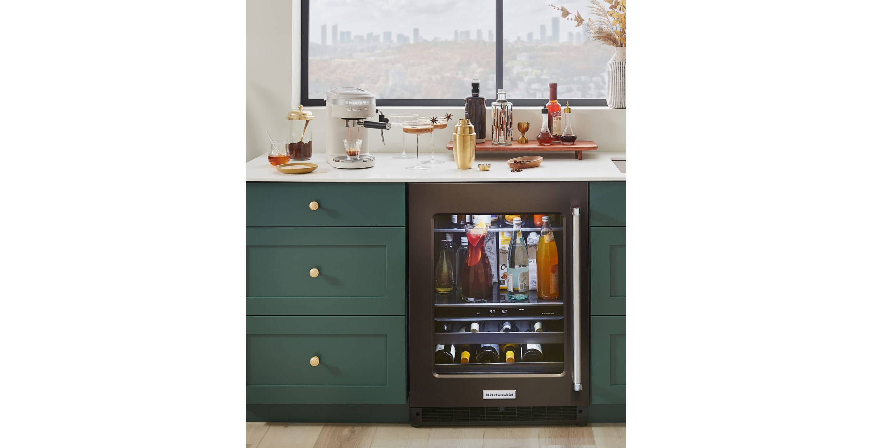 A wet bar decorated with seasonal decor and KitchenAid® appliances making espresso martinis.