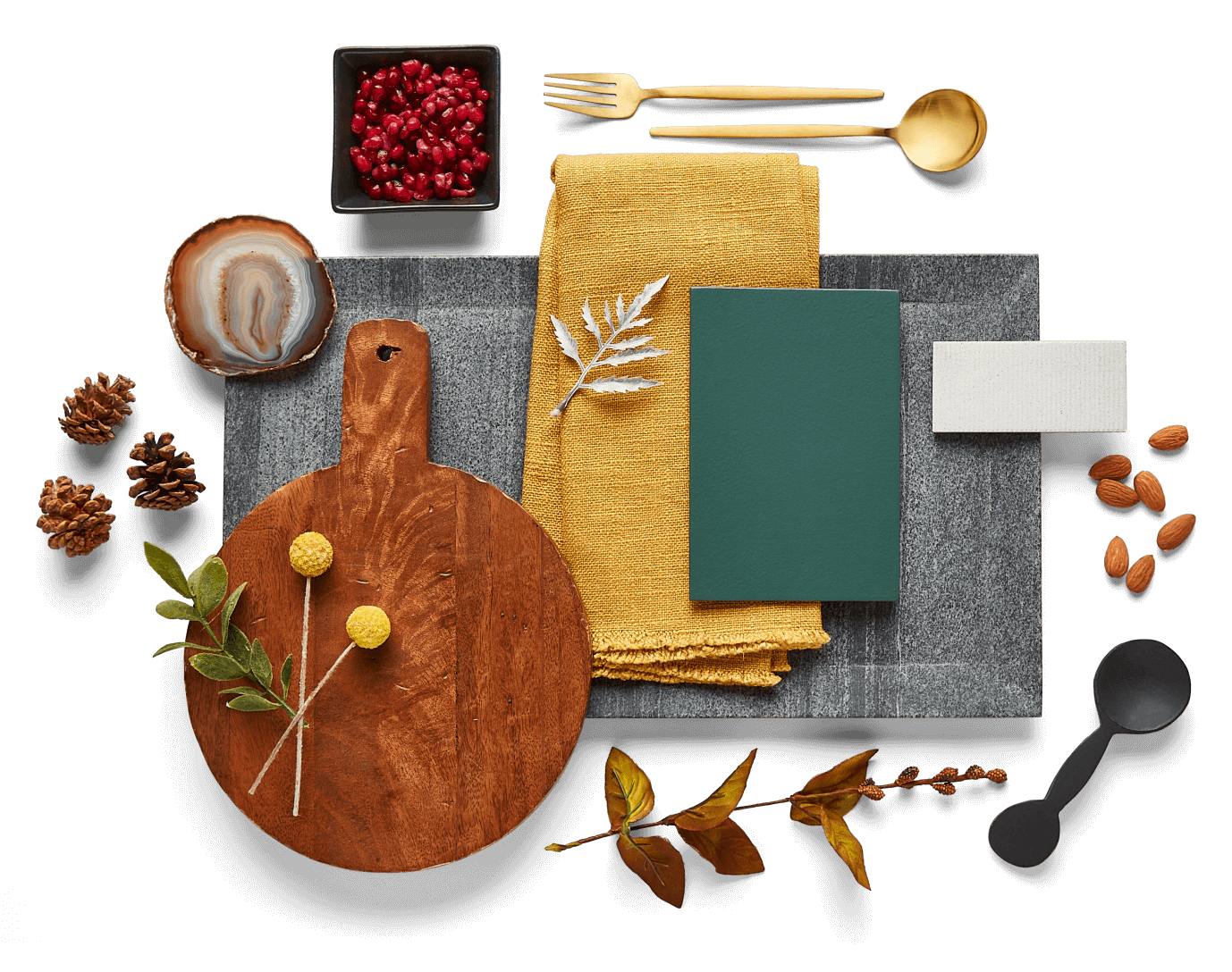 Festive cooking accessories, cutting boards and linens accented by seasonal greenery, foods and materials.