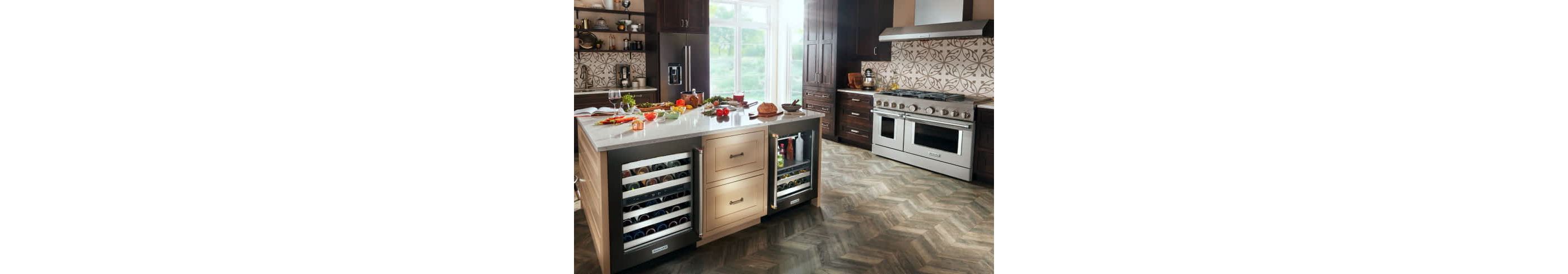 A rich, modern kitchen filled with KitchenAid® appliances and an island with different ingredients across the countertop.