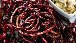 Roasted beet strings with balsamic goat cheese dip on a plate.