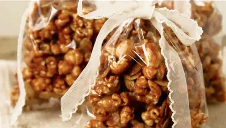 Pumpkin spice caramel corn in a clear bag, tied with a ribbon.