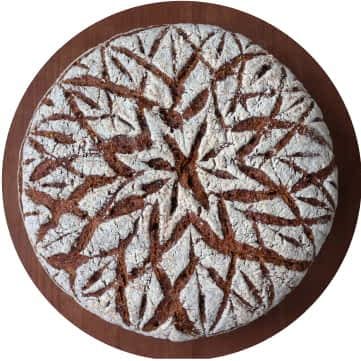 A royal flower design on baked bread.