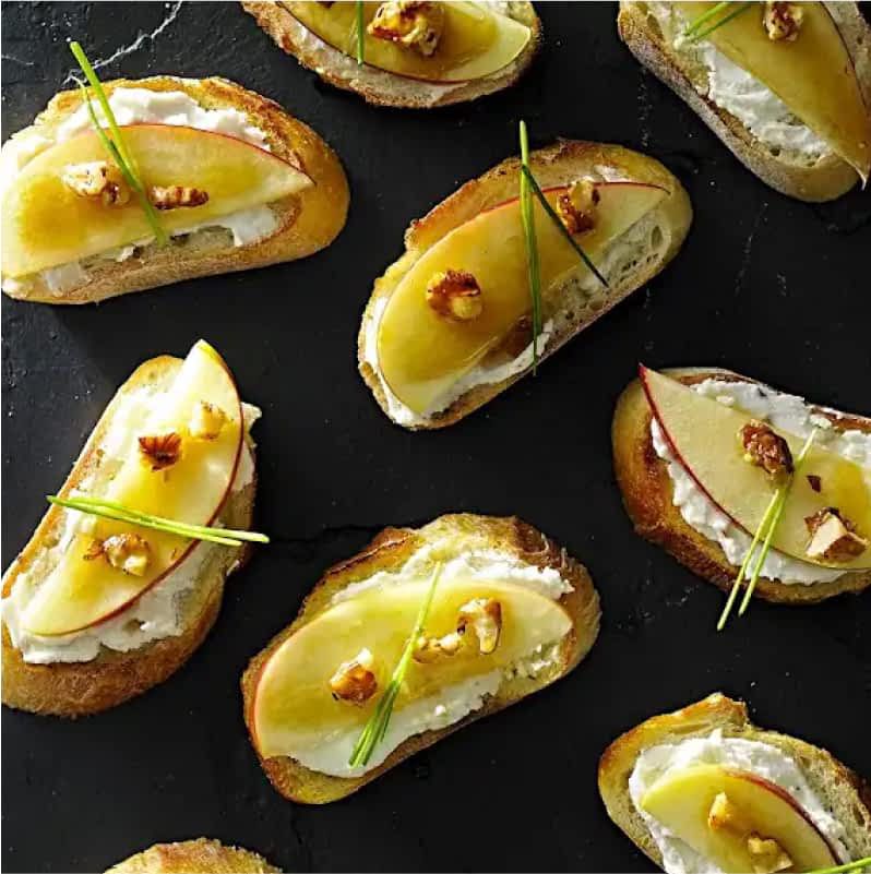Garnished apple brie crostinis.