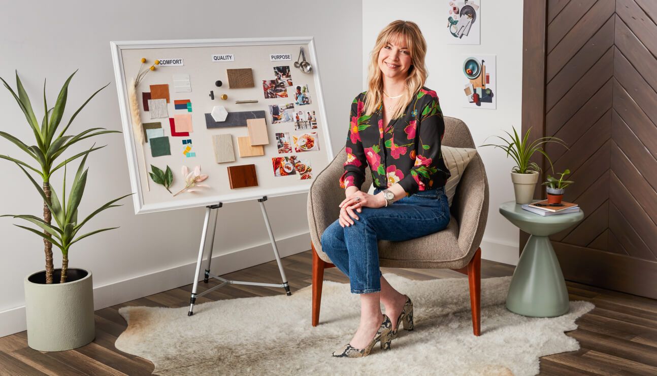 KitchenAid Designer Jessica McConnell in black floral top seated by inspiration board.