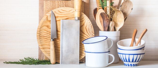 Collection of chef’s knives, bowls, mugs and wooden spoons.