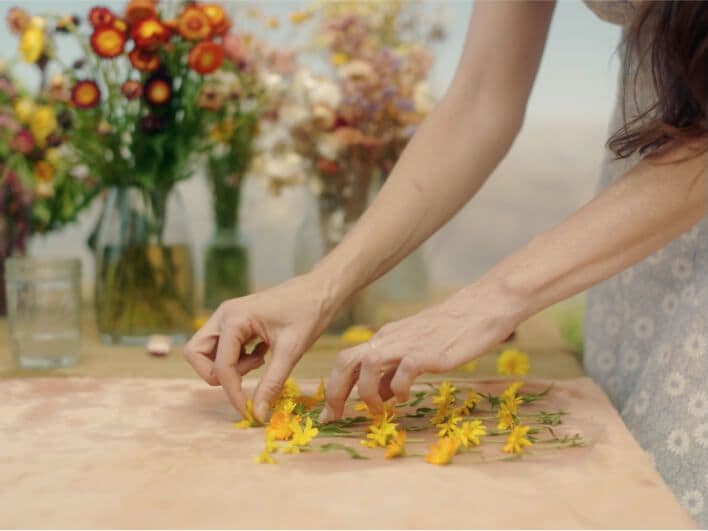 A woman arranging delicate flowers.