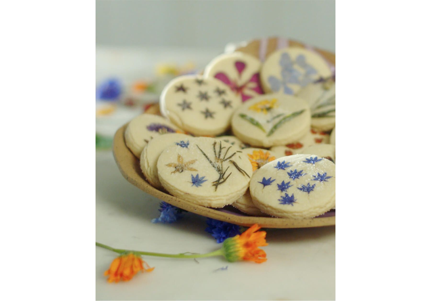 Freshly baked cookies with pressed flowers baked in.