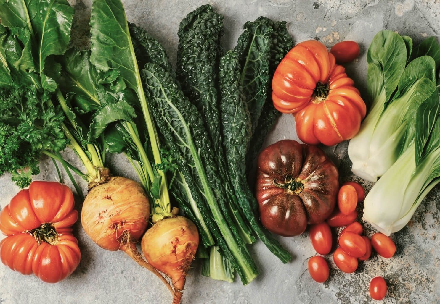 A table filled with a variety of whole vegetables.