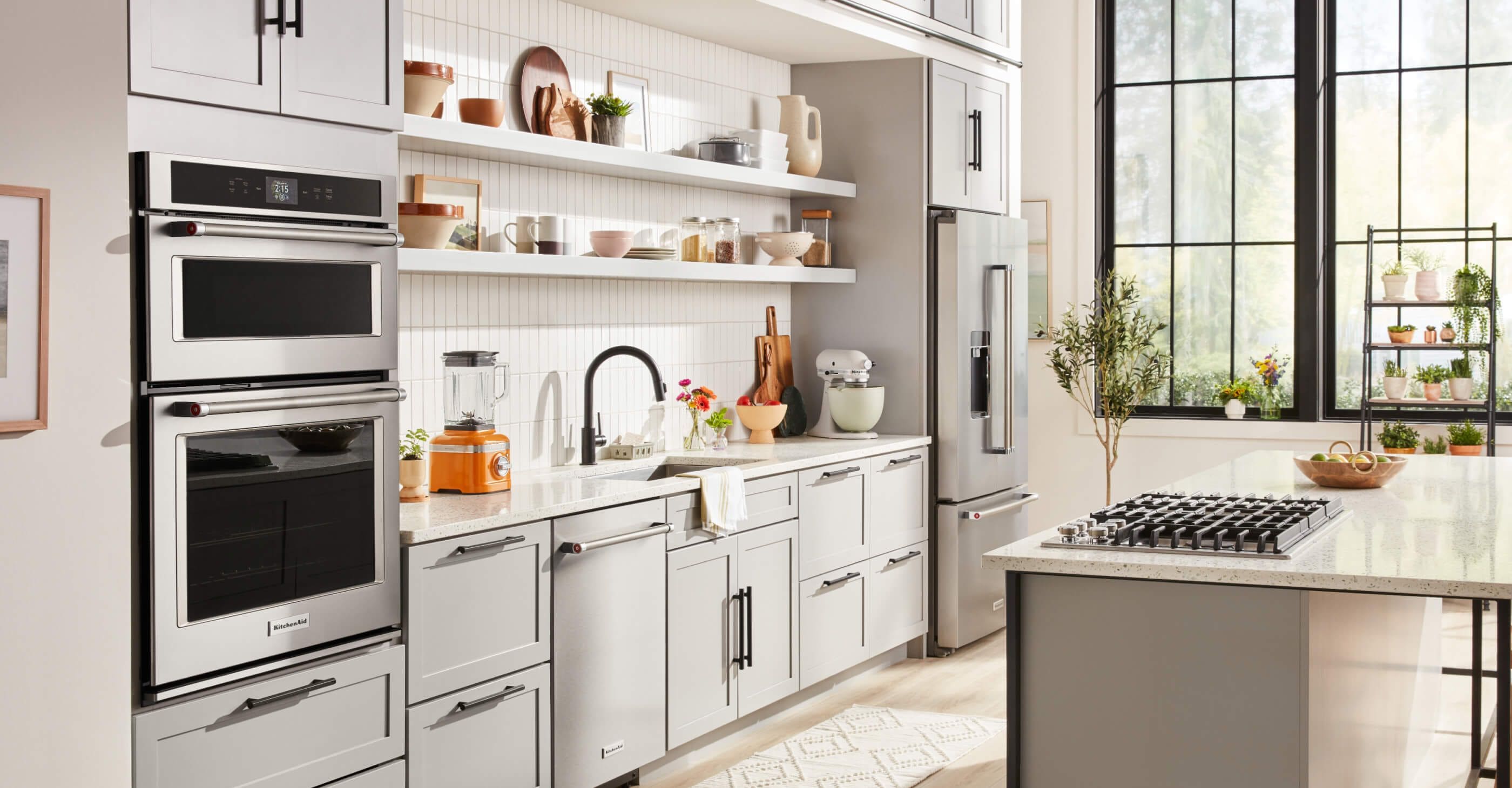 A bright, white kitchen featuring a variety of KitchenAid® small and large appliances.