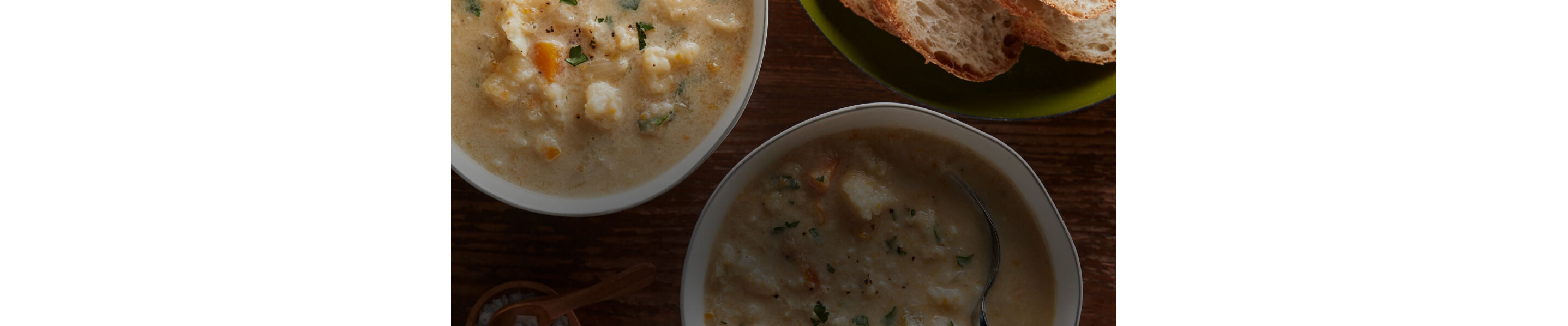 Bowls of soup served with fresh bread.