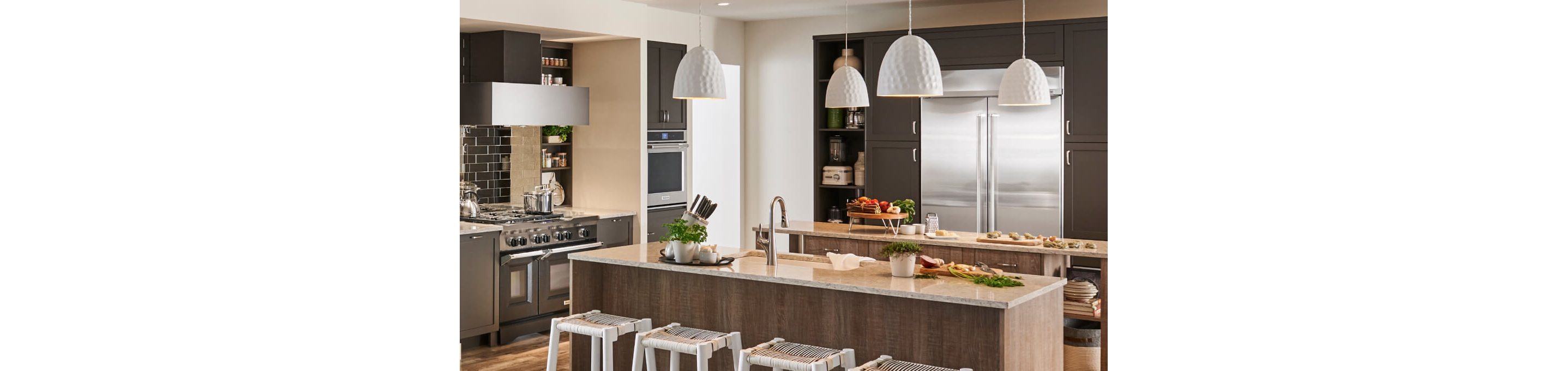 Large kitchen with built-in appliances and two islands.