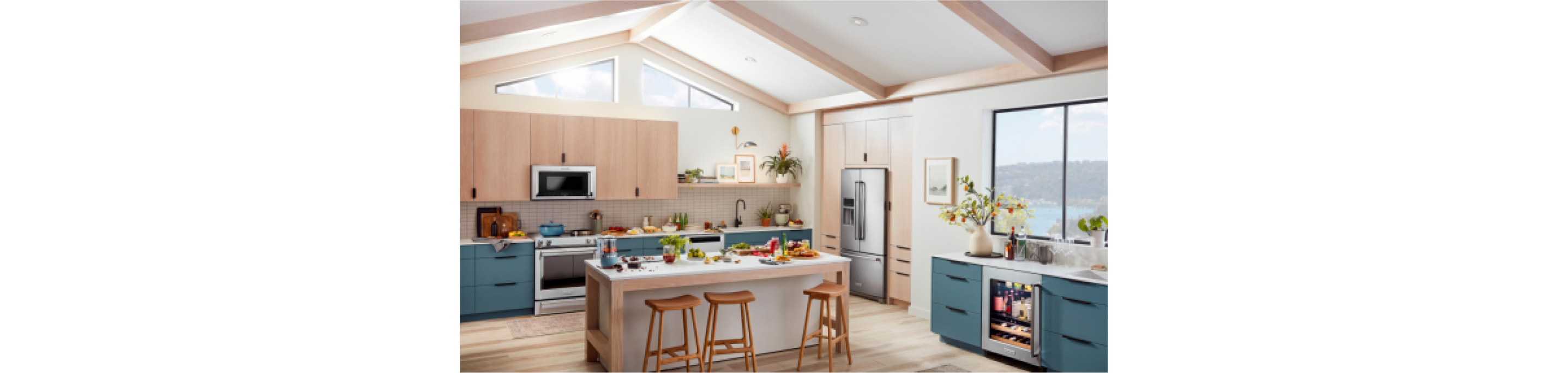 A bright, stylish kitchen outfitted with KitchenAid® appliances, plus teal and wood cabinets. 