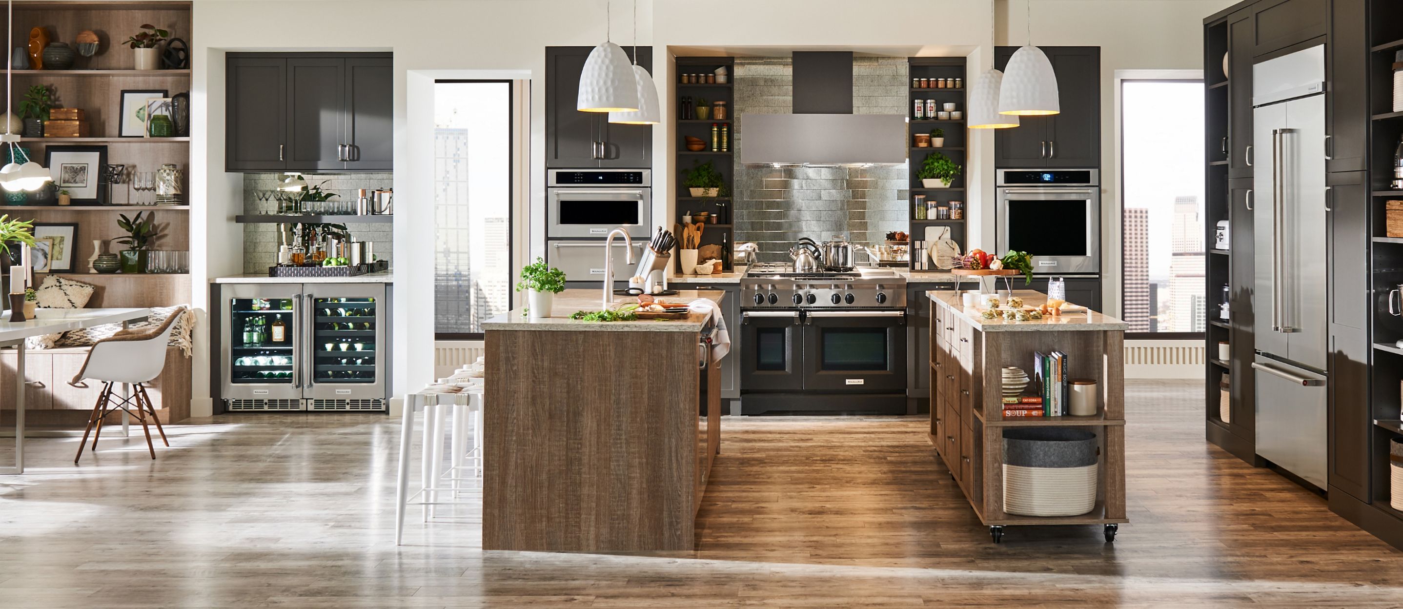 A large modern kitchen with a double island and a suite of built-in appliances. 